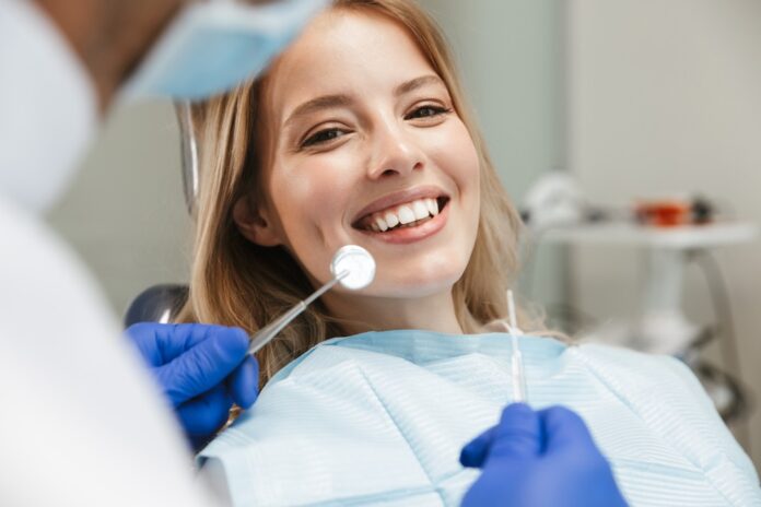 Image,Of,Satisfied,Young,Woman,Sitting,In,Dental,Chair,At